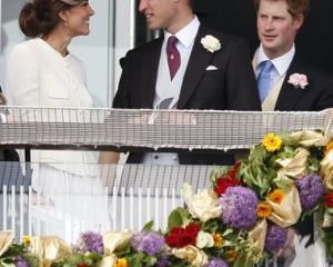 Britain's Duke and Duchess of Cambridge, left, and Prince Harry wait for the start of the Derby...