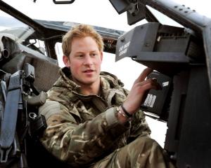 Britain's Prince Harry performs a pre-flight check on his Apache Helicopter at the British...