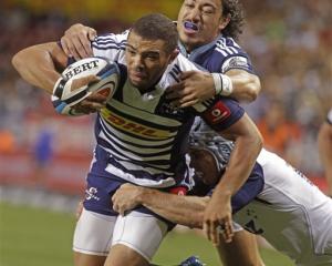 Bryan Habana, left, of the Stormers makes his way to the tryline in the tackle of Ben Lam, of the...