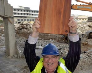 Carisbrook Rotary Project committee member Lindsay Thorburn holds a rimu chopping board at...