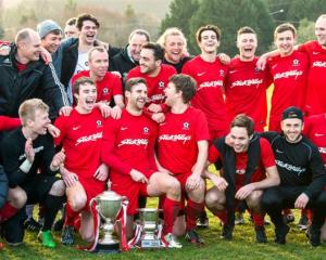 Caversham players celebrate another Football South Premier League title at Sunnyvale on Saturday....
