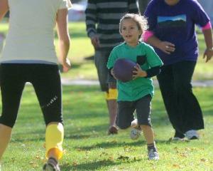 Charlie Jackson (4), of Dunedin, plays ti uru with adults at the Otago Museum Reserve during  the...