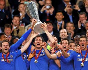 Chelsea players celebrate with the trophy after defeating Benfica in the Europa League final at...