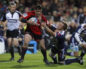 Cory Flynn of the Crusaders is tackled during the round eight Super 15 match against the Stormers...
