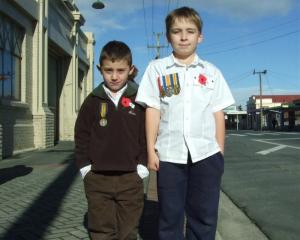 Cousins Seth Rogan (6), of Milton with his great-great-great-uncle's medal, and Jordan Rogan (9),...