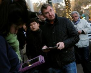 Customers wait in line for the initial sales of the iPad mini at Apple's retail store in Palo...
