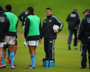 Dan Carter helps deliver water during an All Black training session at Trusts Stadium in Auckland...