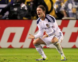 David Beckham reacts after teammate Landon Donovan scored against the Houston Dynamo during the...