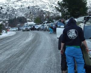 Drivers bound for Coronet Peak fit, or attempt to fit, snow chains on over 20 vehicles including...