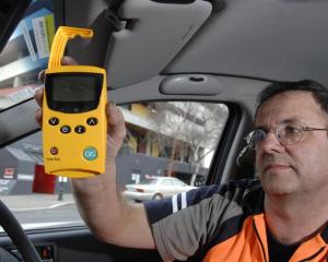 Dunedin City Council meter technician Paul Johnson demonstrates the new SmartPark device in...