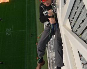 Dunedin Mayor Dave Cull begins his descent for charity from the Forsyth Barr Stadium roof to the...