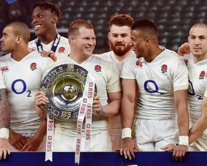 England players celebrate with the trophy after winning the Triple Crown. Photo: Reuters