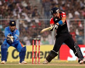 England's Kevin Pietersen plays a shot as India captain MS Dhoni watches during their Twenty20...