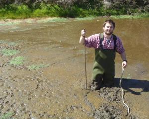 Environment Southland aquatic ecologist Dr Andy Hicks takes samples from a silt pond on a...