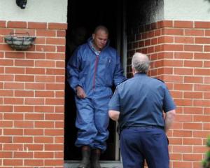 Fire safety and police officers at the scene of a Mosgiel house fire. Photo by Craig Baxter.