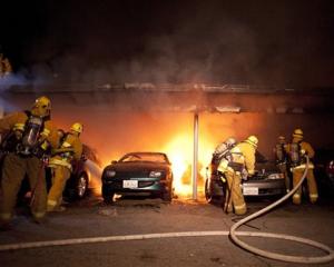 Firefighters tackle a blaze involving numerous cars in the Sherman Oaks neighbourhood of Los...