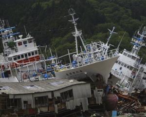 Fishing boats washed ashore by the March 11 earthquake are seen in Kesennuma, Miyagi Prefecture,...