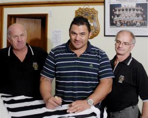 Former All Black prop Kees Meeuws signs a Southern jersey at the clubrooms in Dunedin yesterday,...