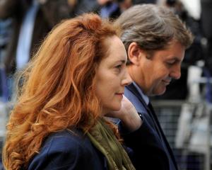 Former News International chief executive Rebekah Brooks and her husband Charlie Brooks arrive at...