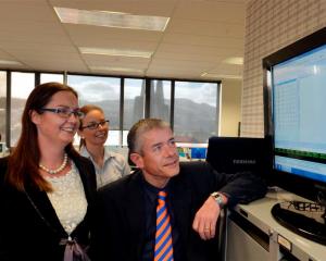 Forsyth Barr brokers (from left) Suzanne Kinnaird, Haley Van Leeuwen and Tom Bliss watch the...