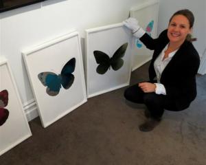 Gallery owner Nadene Milne, of Arrowtown, with limited edition prints by  Damien Hirst. Photo by...