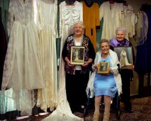 Gladys Morris (85), Nancy Edwards (97) and Noelene Wilson (82) pose with their wedding dresses...