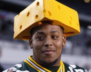 Green Bay Packers centre Adrian Battles wears a cheese-head hat during media day at Cowboys...