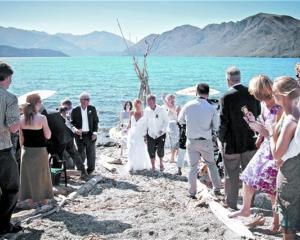Guests wish Catherine Lyness and Nigel Anderson well after they were married on a Lake Wanaka...