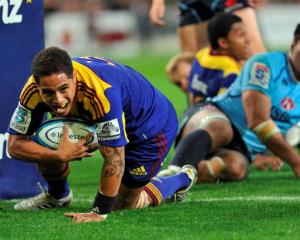 Highlanders halfback Aaron Smith scores a try during his team's round three Super 15 match...