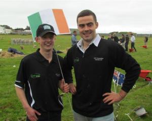 Ireland competitors Graham Murphy and Richie O'Hara raise their flag after completing the...
