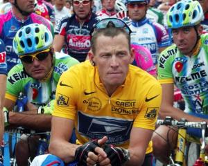 Lance Armstrong of the US waits in front of the pack of riders for the start of the 89th Tour de...