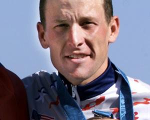 Lance Armstrong poses with his bronze medal after the men's Olympic individual time trial in...
