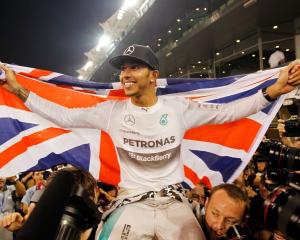 Lewis Hamilton celebrates with his team after winning the Abu Dhabi Grand Prix at the Yas Marina...