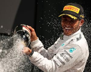 Lewis Hamilton sprays Champagne as he celebrates winning the British Grand Prix at the...