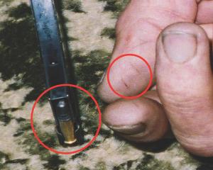 Lines on thumb and edge of magazine (circled). Photo from NZ Police.