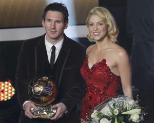 Lionel Messi of Argentina, FIFA World Player of the Year holds his FIFA Ballon d'Or 2011 trophy...