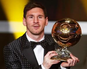 Lionel Messi of Argentina holds the Ballon d'Or trophy during the FIFA Ballon d'Or 2012 football...