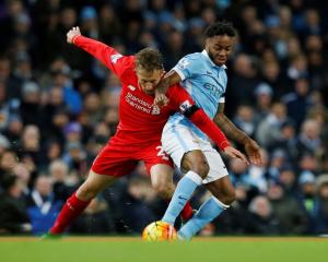 Liverpool's Lucas Leiva vies for the ball with Manchester City's Raheem Sterling. Photo: Reuters