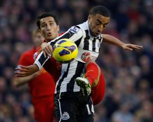 Liverpool's Nuri Sahin (L) challenges Newcastle United's James Perch during their English Premier...