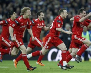 Liverpool's players react after winning on penalties against Cardiff City during their English...