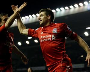 Liverpool's Steven Gerrard (R) celebrates scoring against Everton with teammate Jordan Henderson...