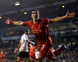 Luis Suarez celebrates after scoring against Tottenham Hotspur at White Hart Lane in London....