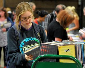 Mackenzie Reid browses  books in the Dunedin Public Libraries' book sale yesterday. Photo by...