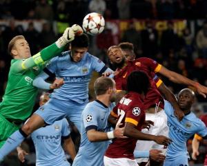 Manchester City goalkeeper Joe Hart (L) makes a save during their Champions League match against...