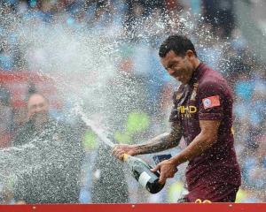 Manchester City's Carlos Tevez celebrates his team's victory over Chelsea in their English...