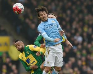 Manchester City's David Silva (R) vies for the ball with Norwich City's Nathan Redmond. Photo:...