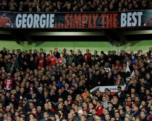 Manchester United fans pay tribute to George Best during the match against PSV Eindhoven. Photo...