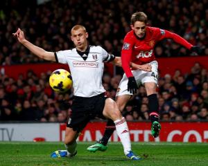 Manchester United's Adnan Januzaj (R) challenges Fulham's Steve Sidwell. REUTERS/Darren Staples