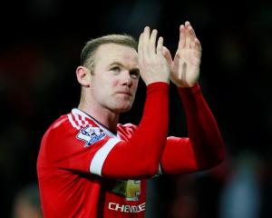 Manchester United's Wayne Rooney applauds fans after the game. Photo Reuters