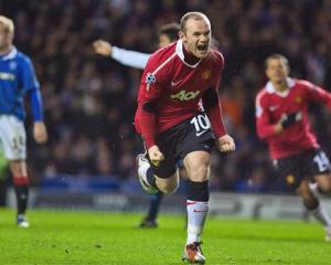 Manchester United's Wayne Rooney celebrates after scoring from the penalty spot against Glasgow...